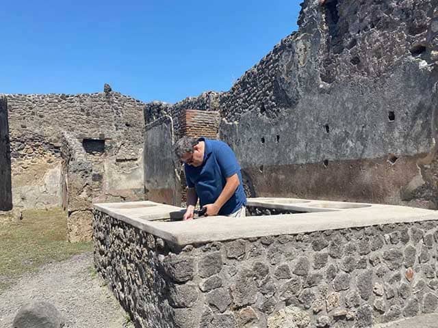 Joel "cooking" in a restaurant among the ruins in Pompeii 